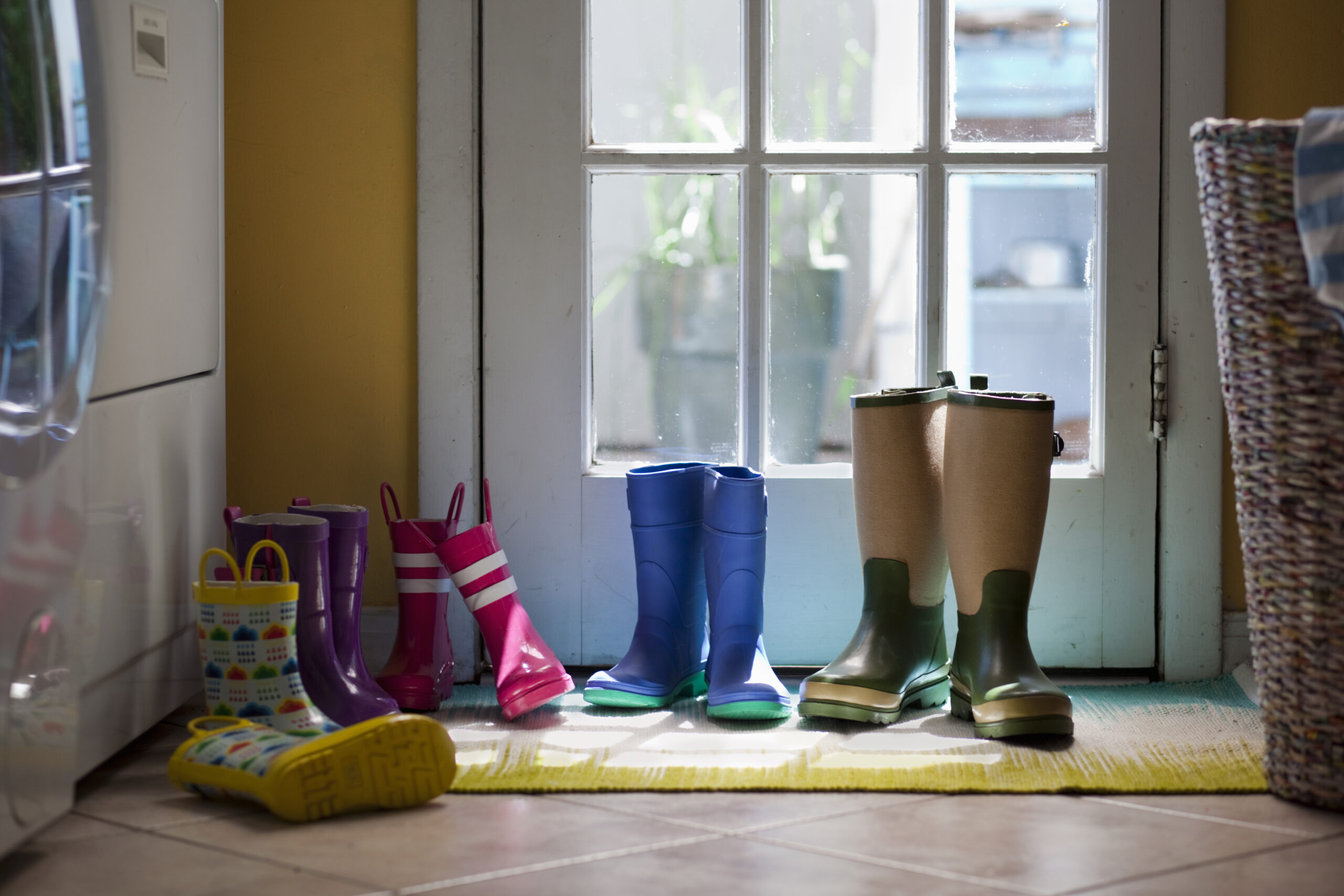 row of rubber boots at back door